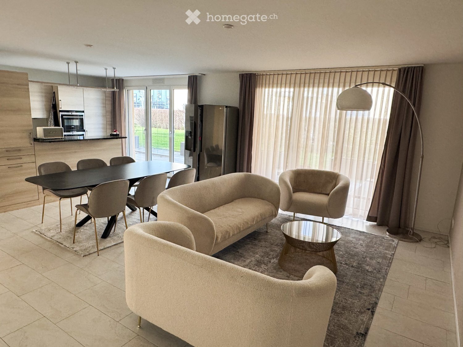large open space, modern furniture, large glass windows, kitchen in background