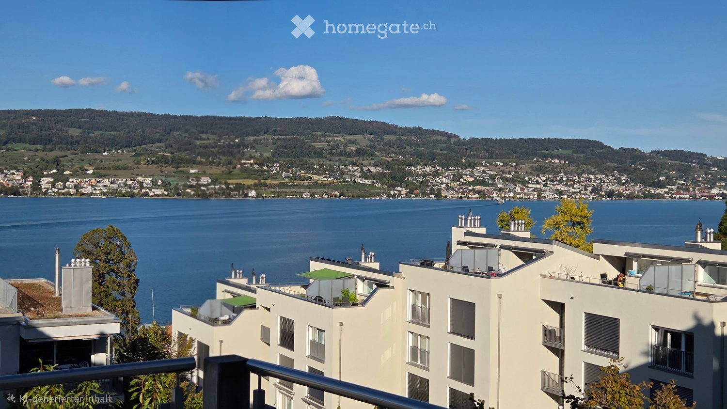 Modern multi-story residential building with balconies and rooftop terraces, overlooking a lake and distant hills.