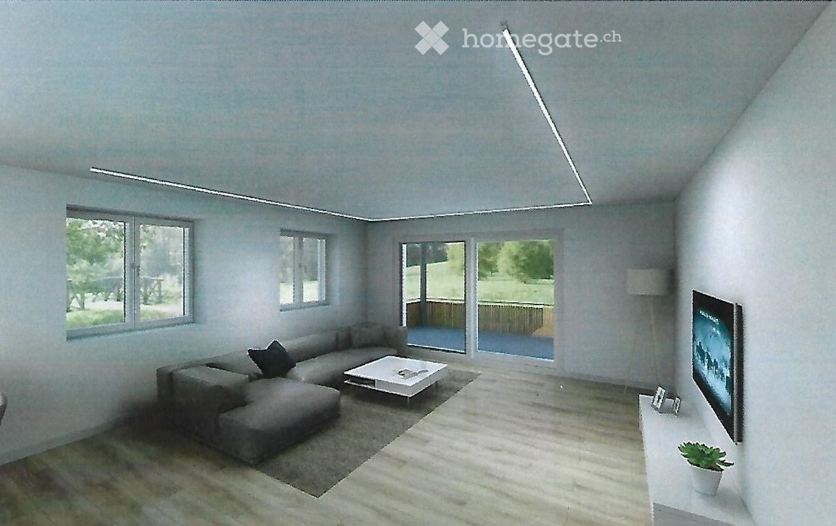 Modern living room with large windows and a sliding glass door leading to a balcony. Features a grey sectional sofa, white coffee table, flat-screen TV, and a small plant on a side table.