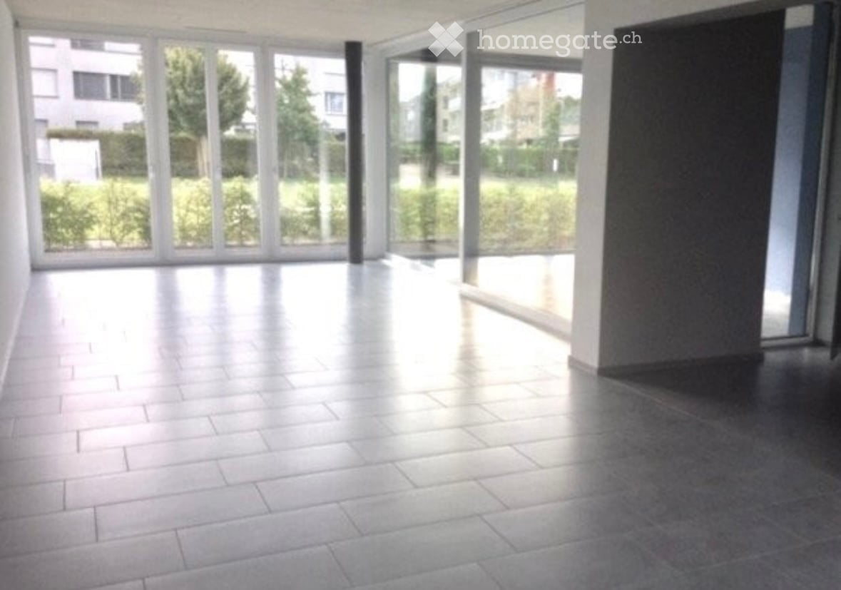Empty room with large windows and tiled flooring, no furniture or equipment present.