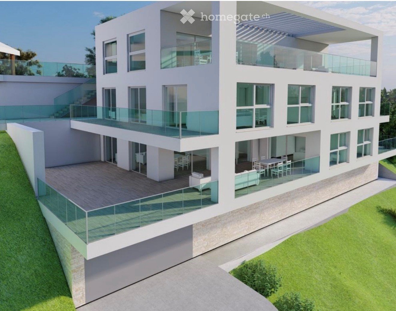 Modern two-story house with white exterior, large windows, multiple balconies, and a raised ground floor. Features include a spacious terrace with outdoor furniture and a staircase leading to the upper level.