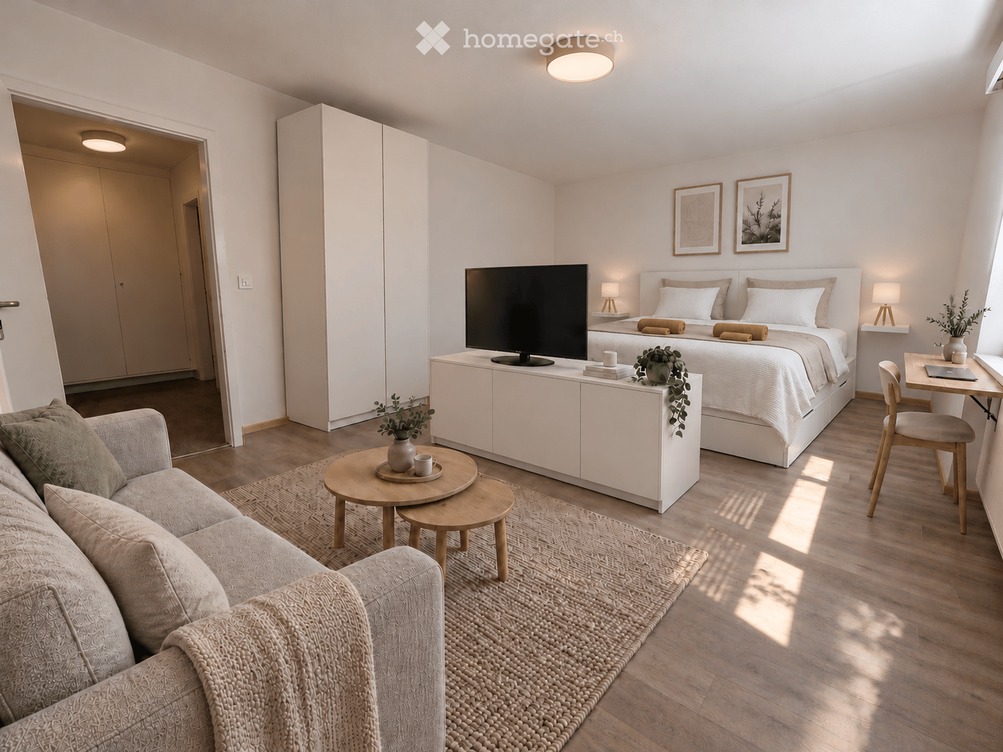 Modern, well-lit bedroom with a sofa, coffee table, bed, nightstand, laptop, chair, and potted plants.