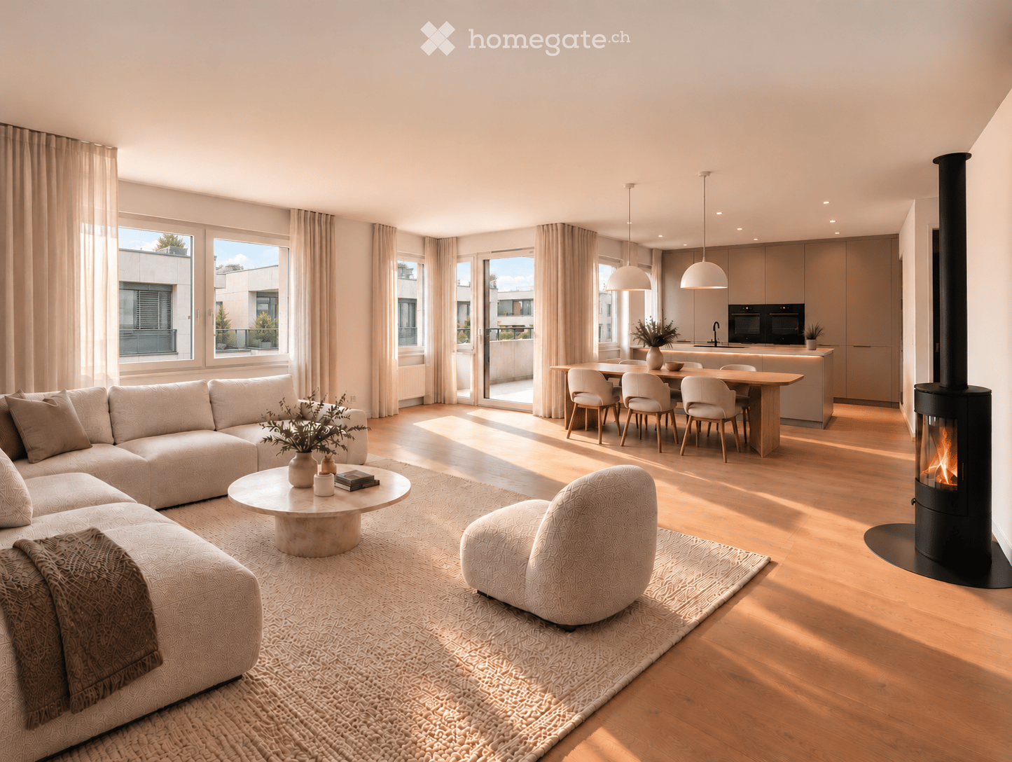 Modern living and dining area with a sectional sofa, coffee table, armchair, dining table with chairs, kitchen island, pendant lights, and a fireplace. Large windows and sliding doors lead to a balcony.
