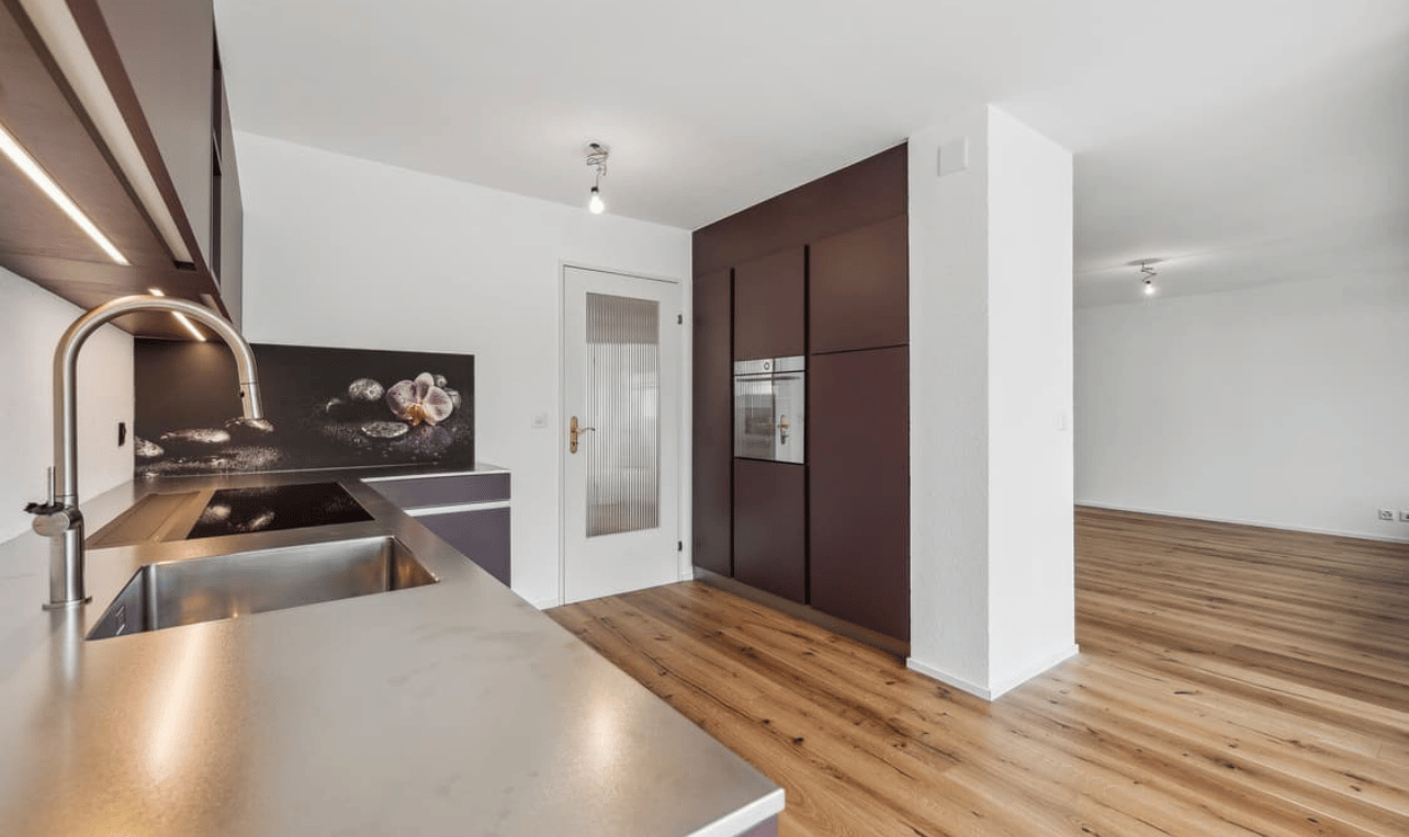 kitchen, modern design, wooden floor, stainless steel countertop, integrated oven, wooden cabinets, large sink, faucet