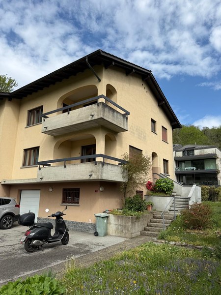 2 story house, beige exterior, garage, balcony, plants, steps, car parked