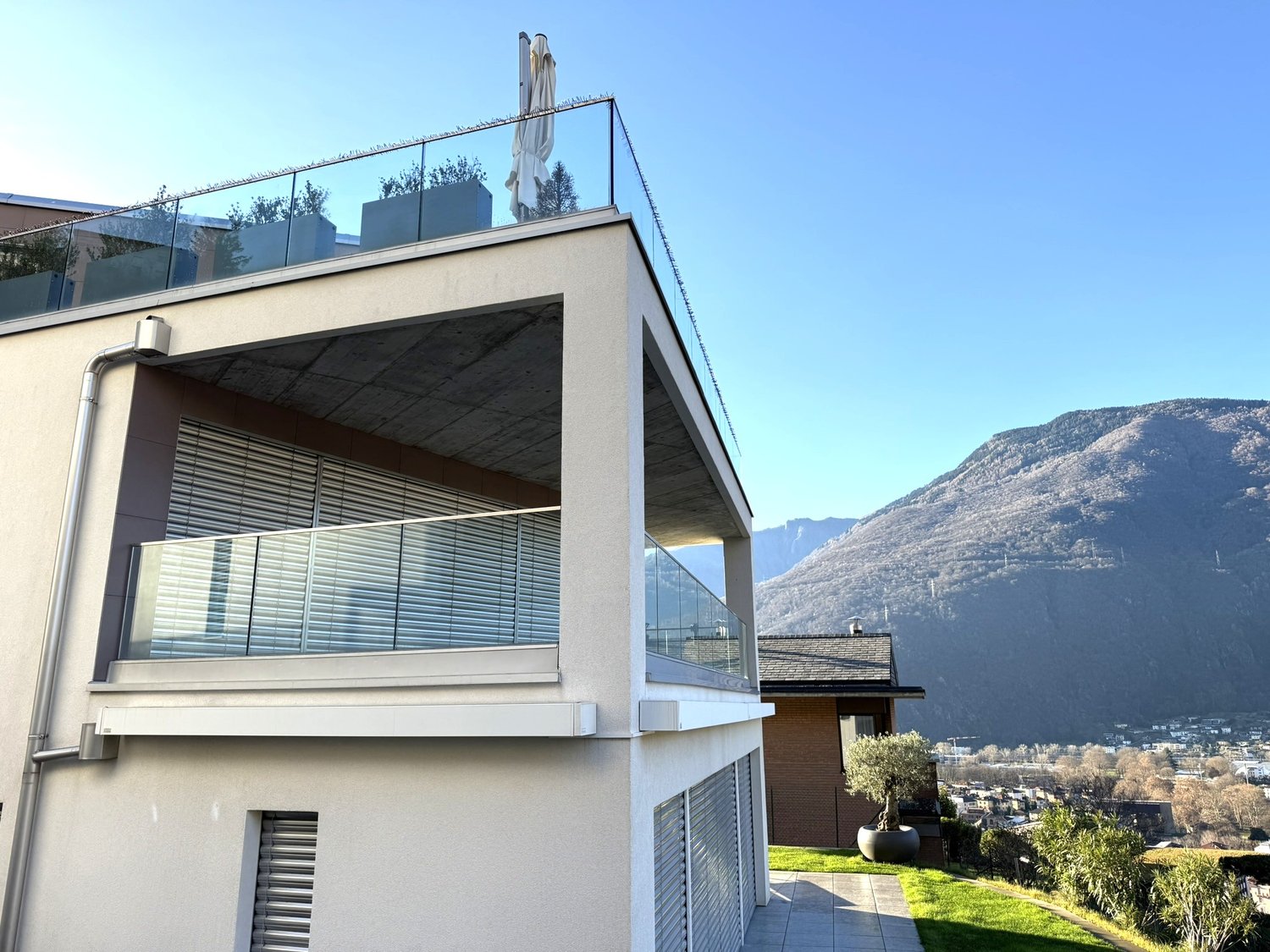 modern house, concrete frame, glass balcony, rooftop terrace, view of mountains