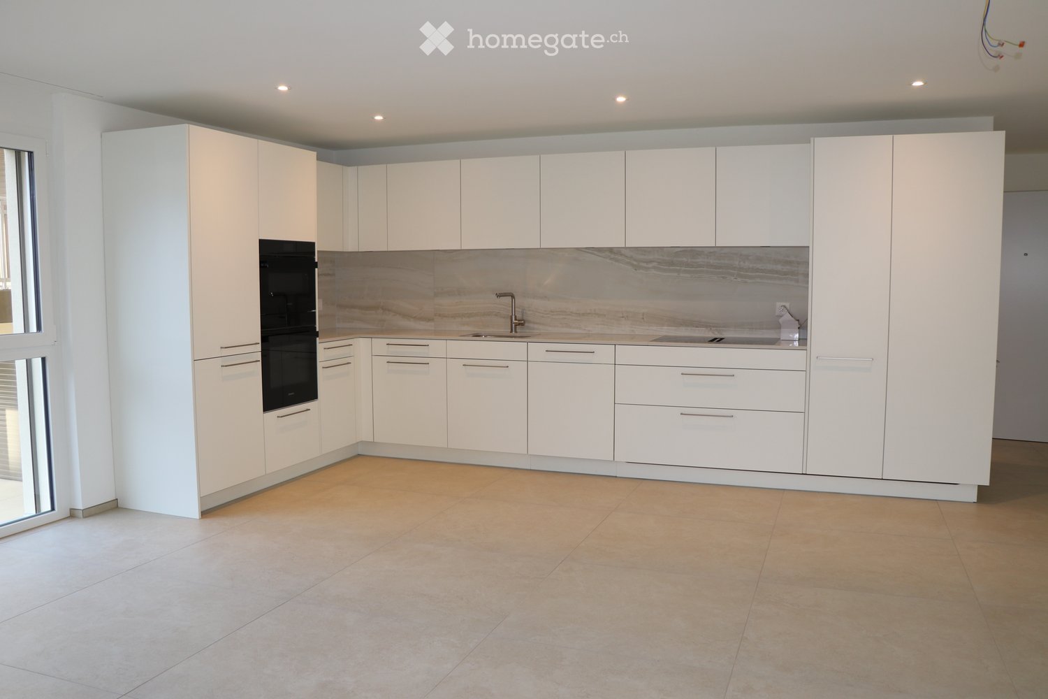 white kitchen, marble countertops, double oven, sink, faucet, glass windows, tiled floor