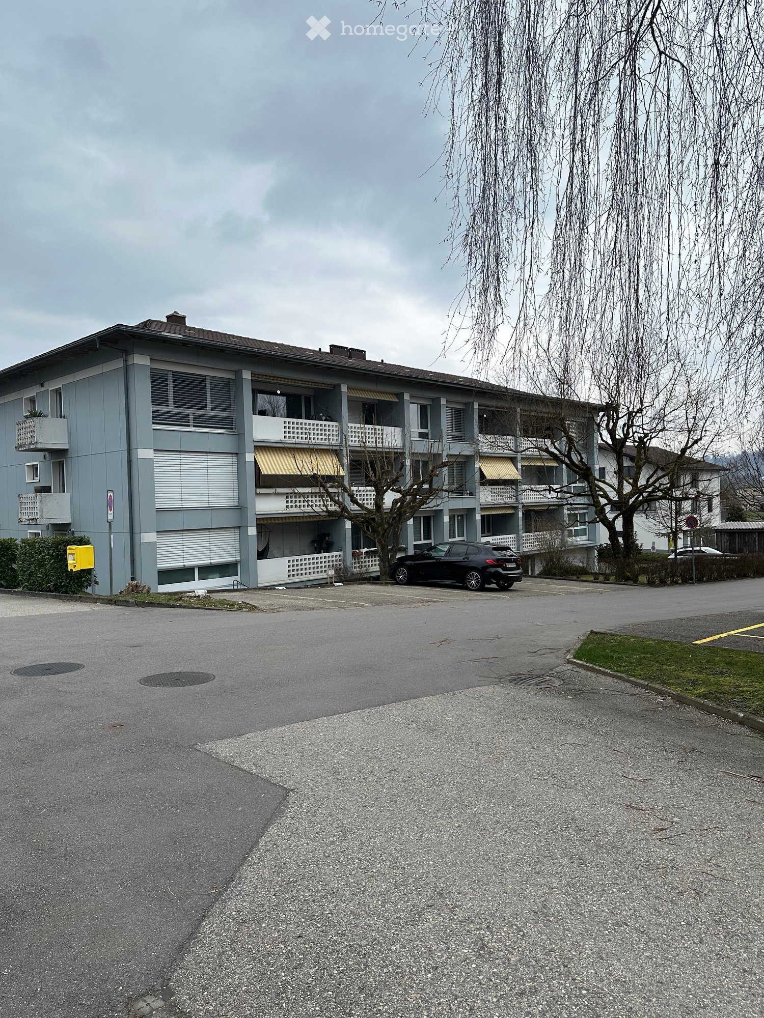 An apartment building with a parking space in front of it