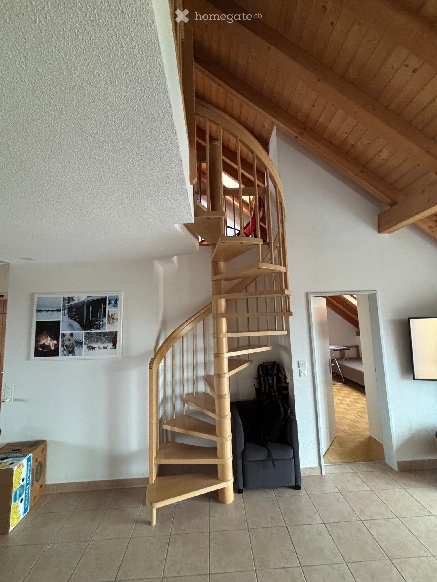 Living room with spiral staircase leading to upper floor