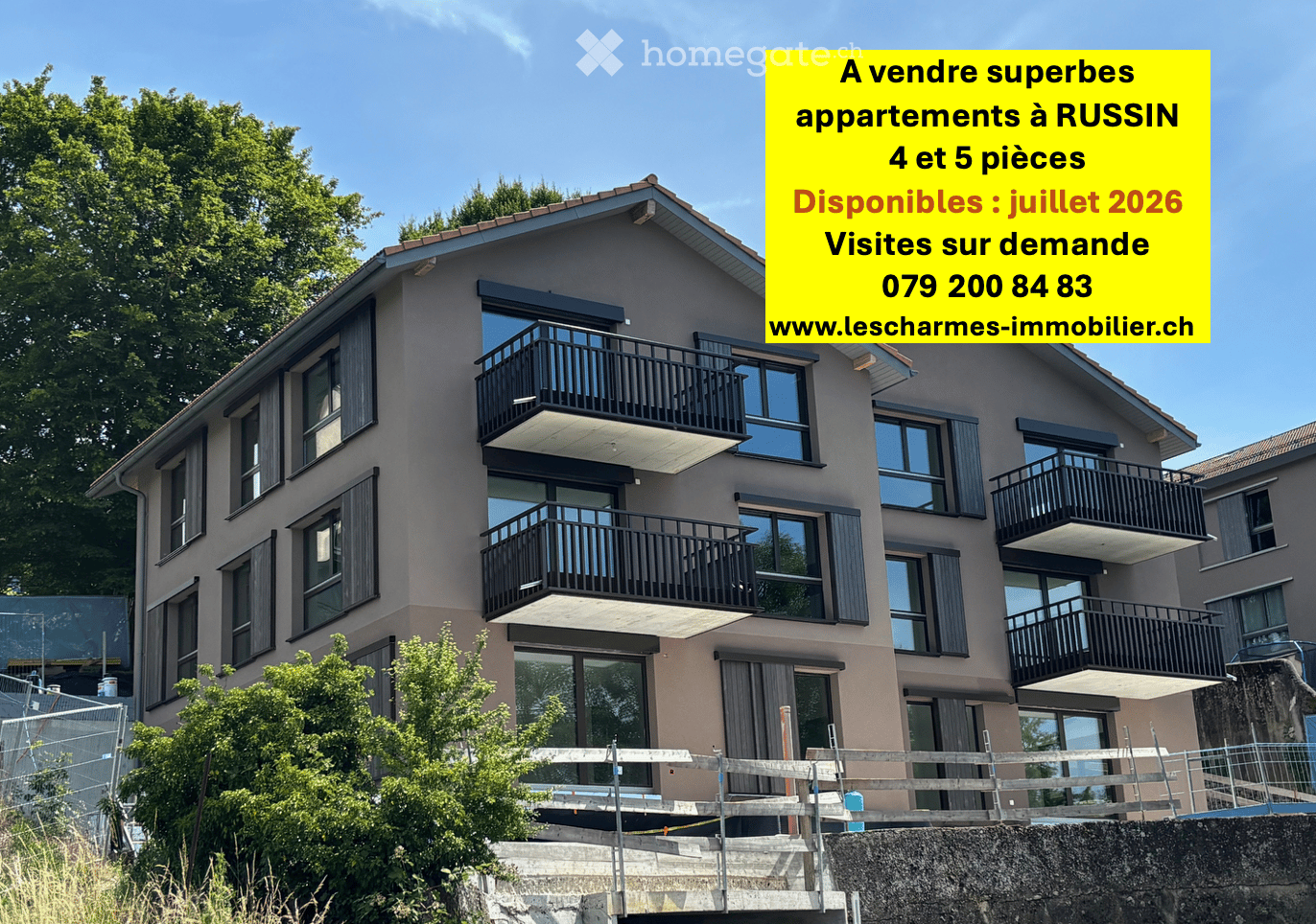 Modern multi-story residential building with balconies, large windows, and a contemporary design.