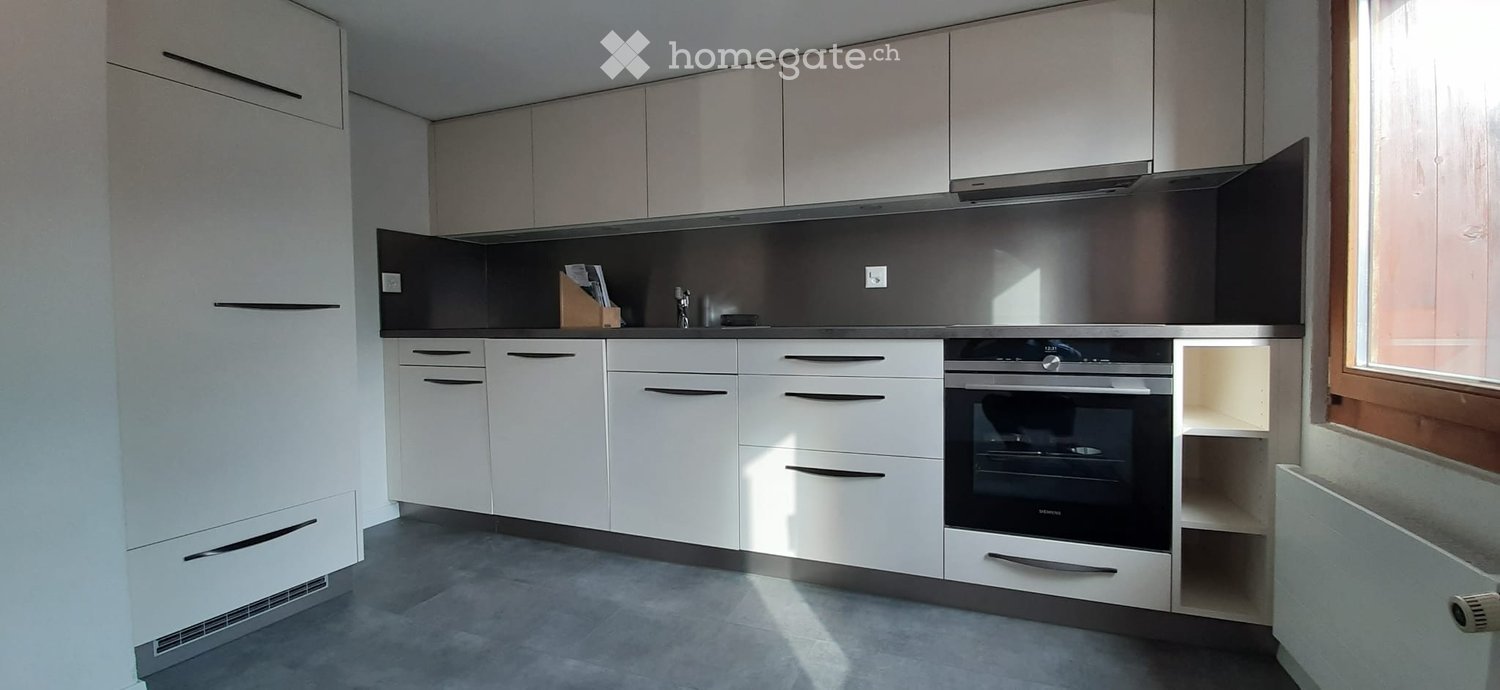Kitchen. Modern kitchen with white cabinets, stainless steel oven, and sleek countertops.
