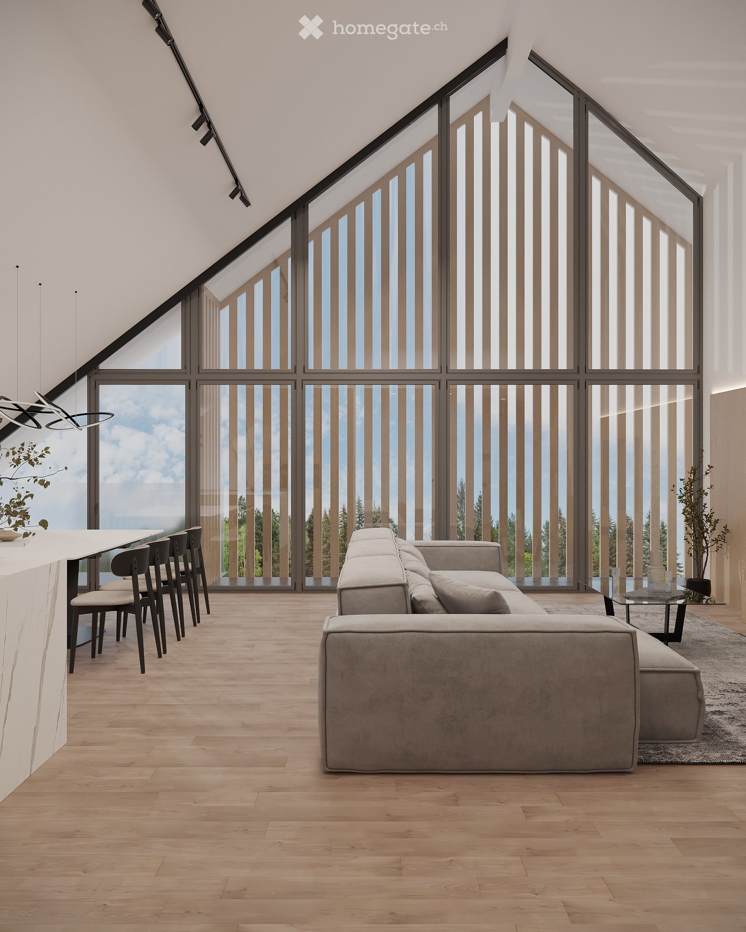 Modern living room with large windows offering a scenic view, featuring a grey sectional sofa, a glass coffee table, a white bar counter with bar stools, and a sleek pendant light fixture.