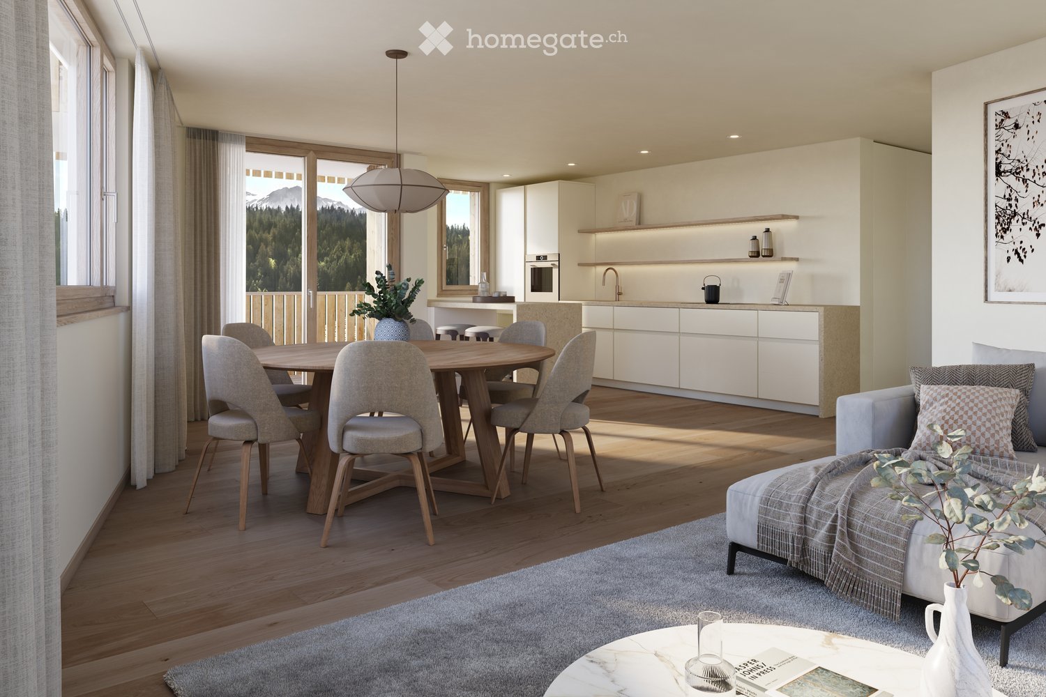 Modern open-plan living and dining area with a view of mountains, featuring a grey sofa, coffee table, dining table with chairs, and a sleek white kitchen with cabinets and appliances.