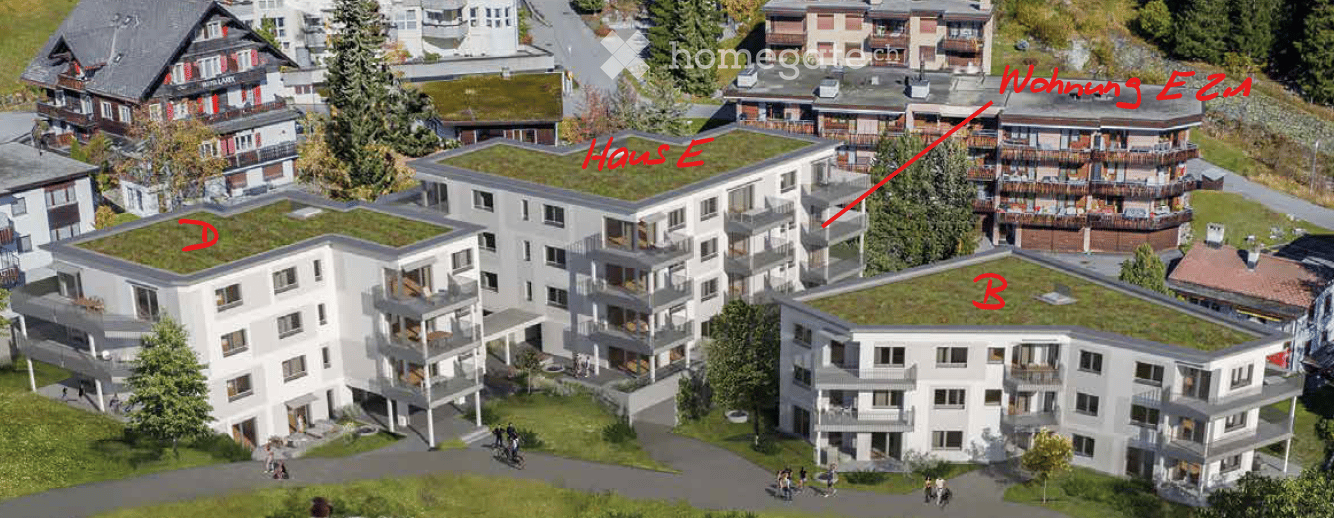 Aerial view of a modern residential complex with multiple buildings, green roofs, balconies, and surrounding greenery.