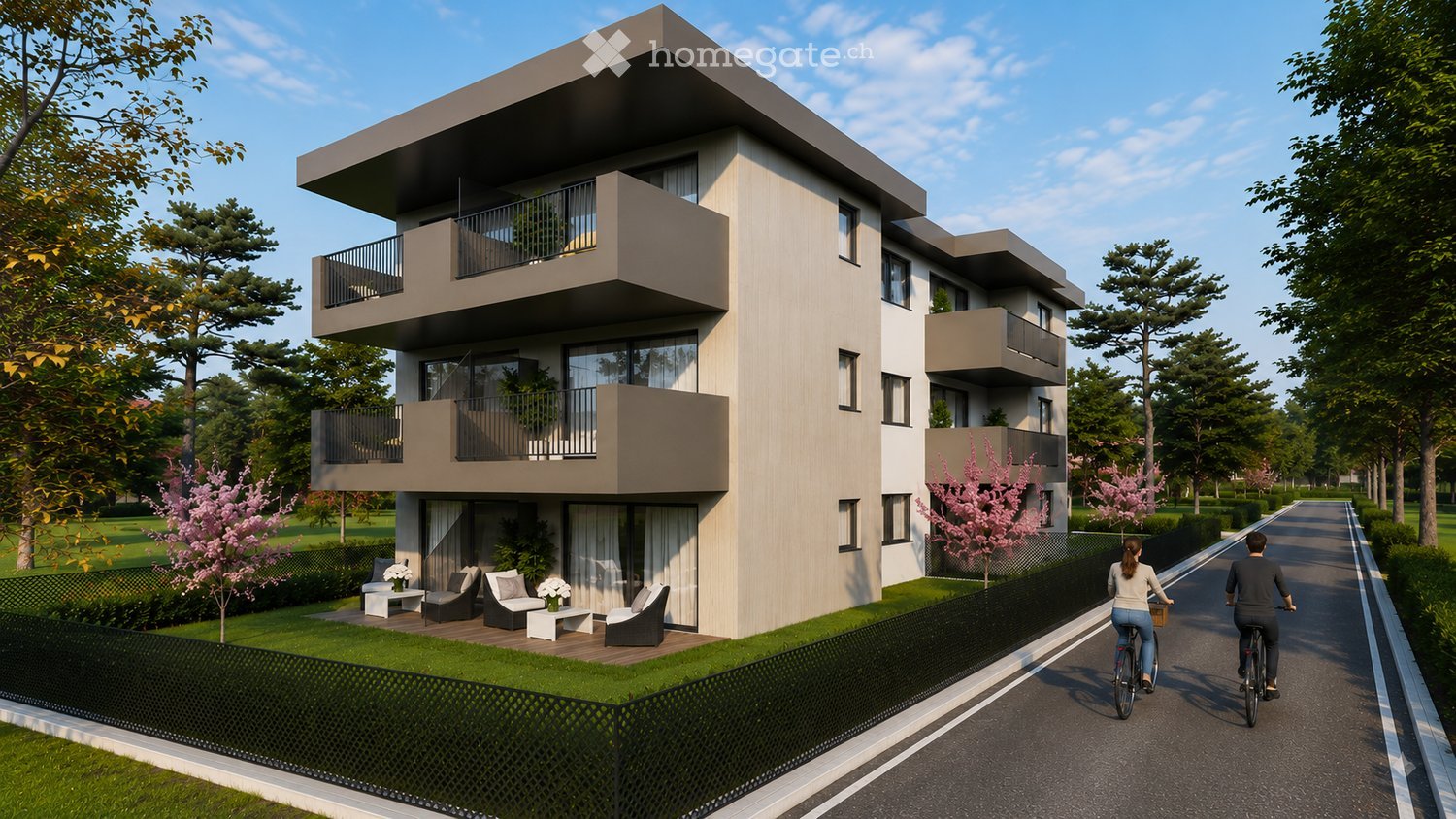 Modern multi-story residential building with balconies, surrounded by greenery and a paved pathway.