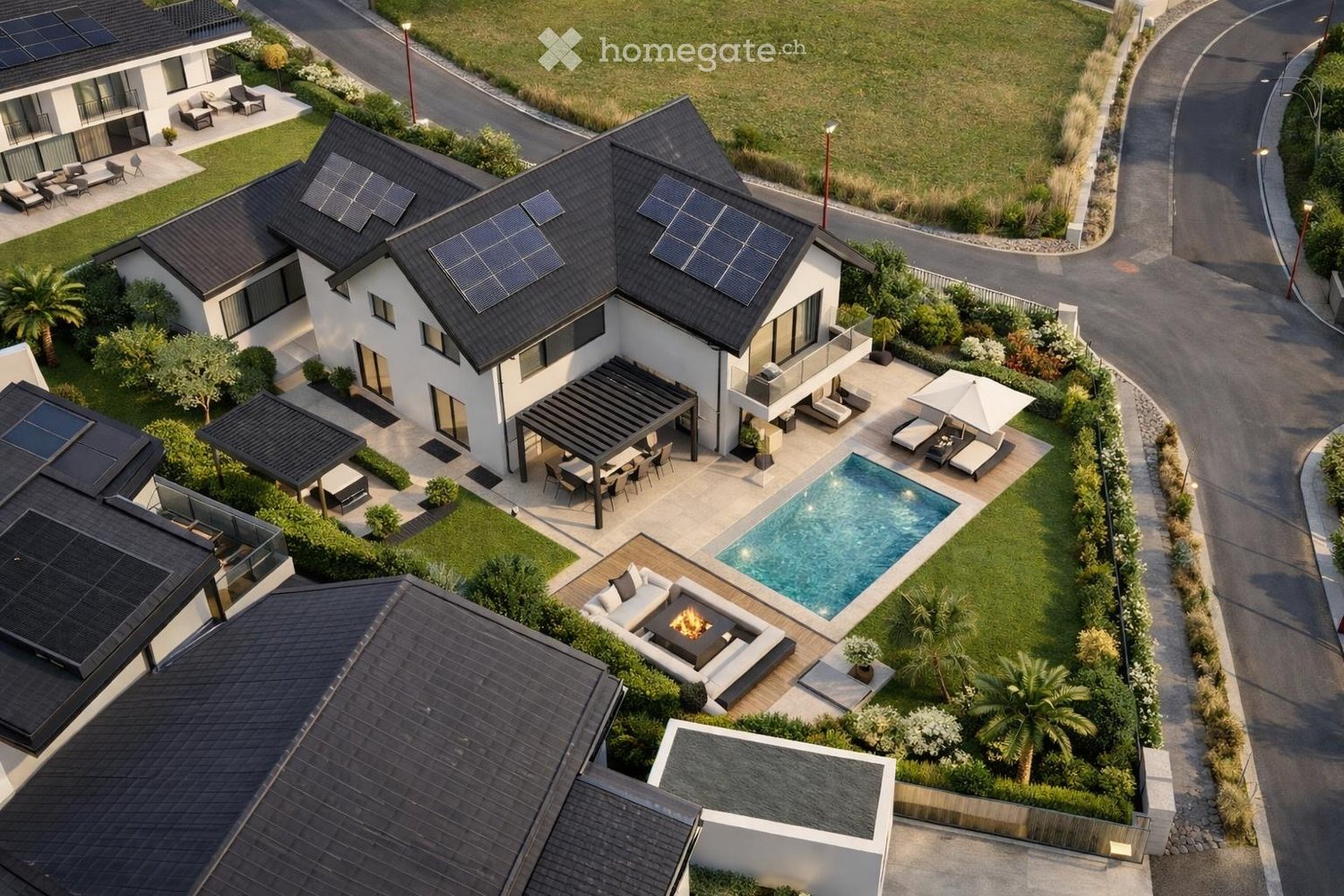 Aerial view of a modern two-story house with solar panels on the roof, surrounded by a landscaped garden, swimming pool, patio, and outdoor seating areas.