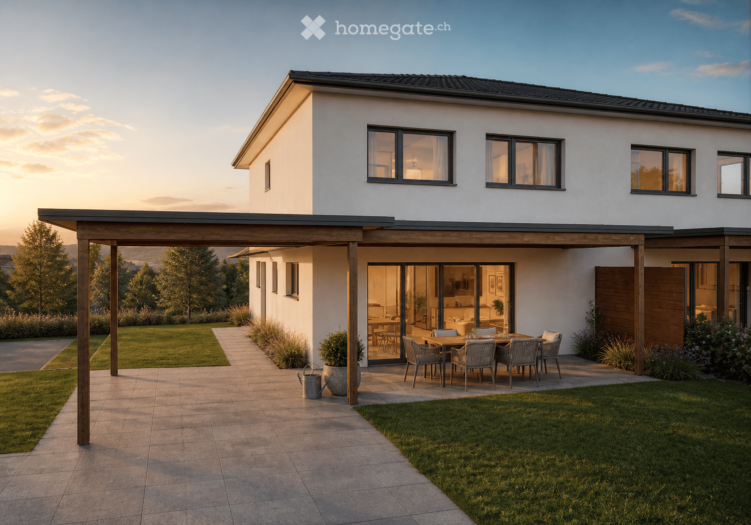Modern two-story house with white exterior, large windows, covered patio with outdoor dining set, well-maintained lawn, and garden area.