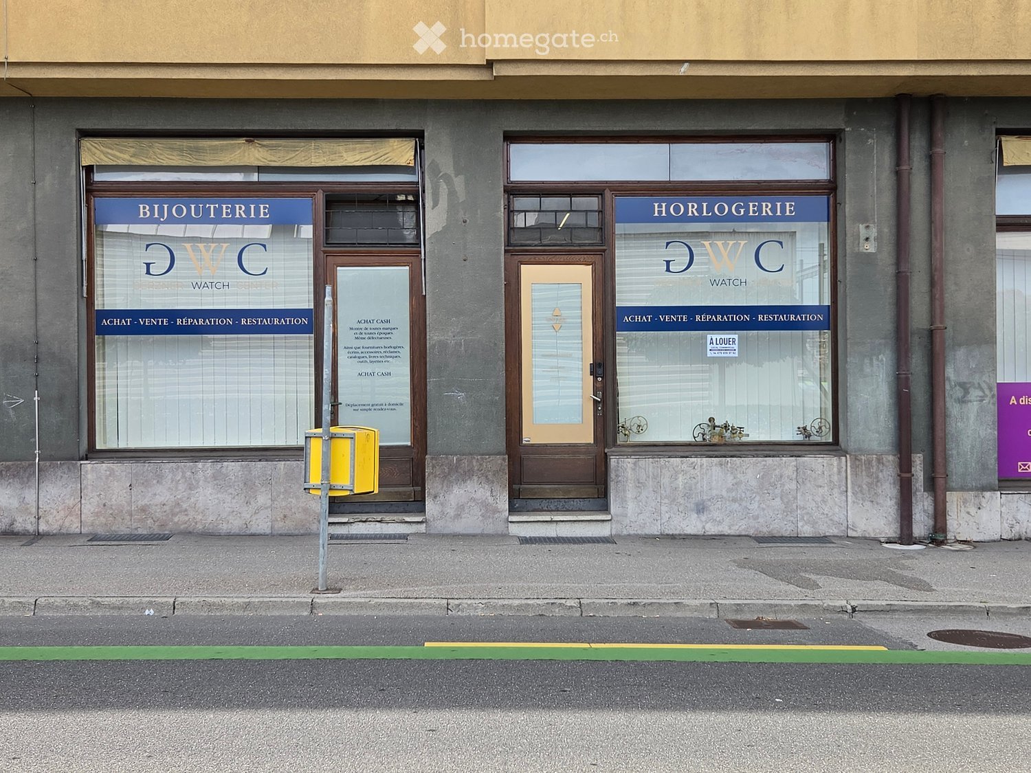 Two storefronts on a building facade, one labeled "BIJOUTERIE" and the other "HORLOGERIE" with glass windows and wooden doors.
