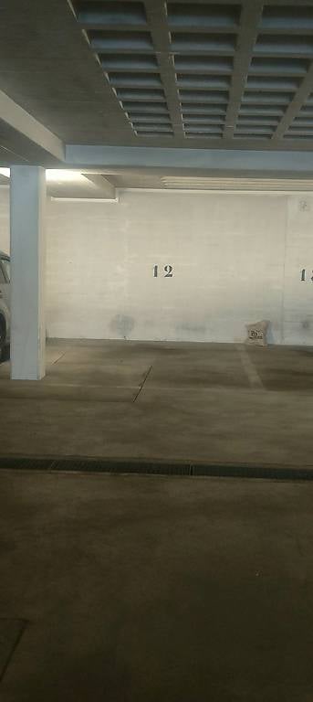 {"type": "Parking place", "objects": [], "description": "Empty parking space in a multi-level garage with concrete floors and walls, numbered stall12 visible.", "localized_descriptions": {"EN": "Empty parking space in a multi-level garage with concrete fl