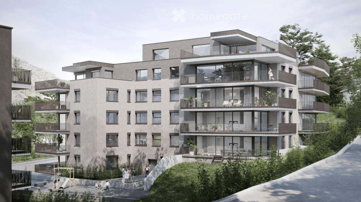 Modern apartment building with multiple balconies, glass walls, and a green area