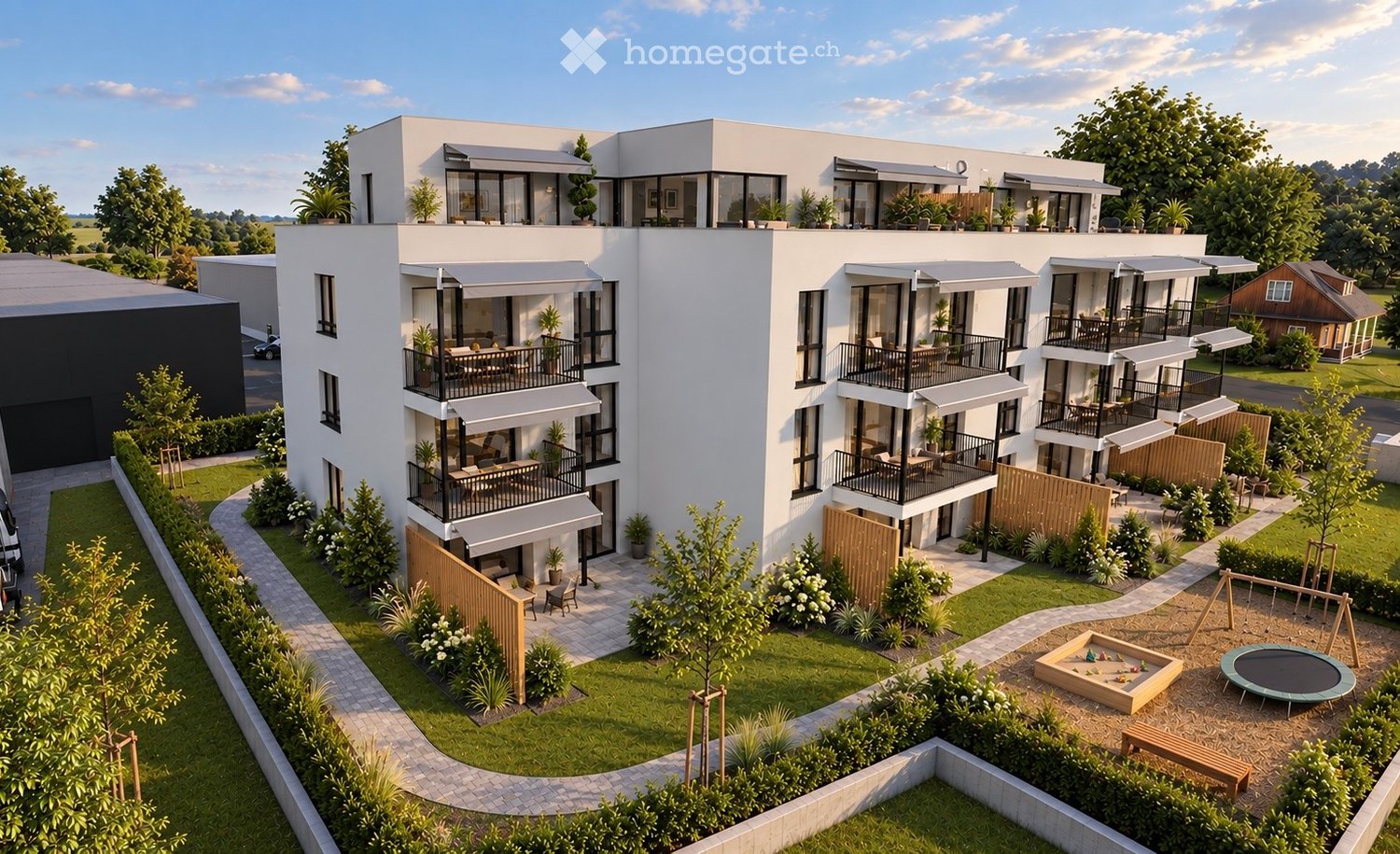 Modern multi-story residential building with balconies, outdoor seating areas, and surrounding greenery including a playground and trampoline.