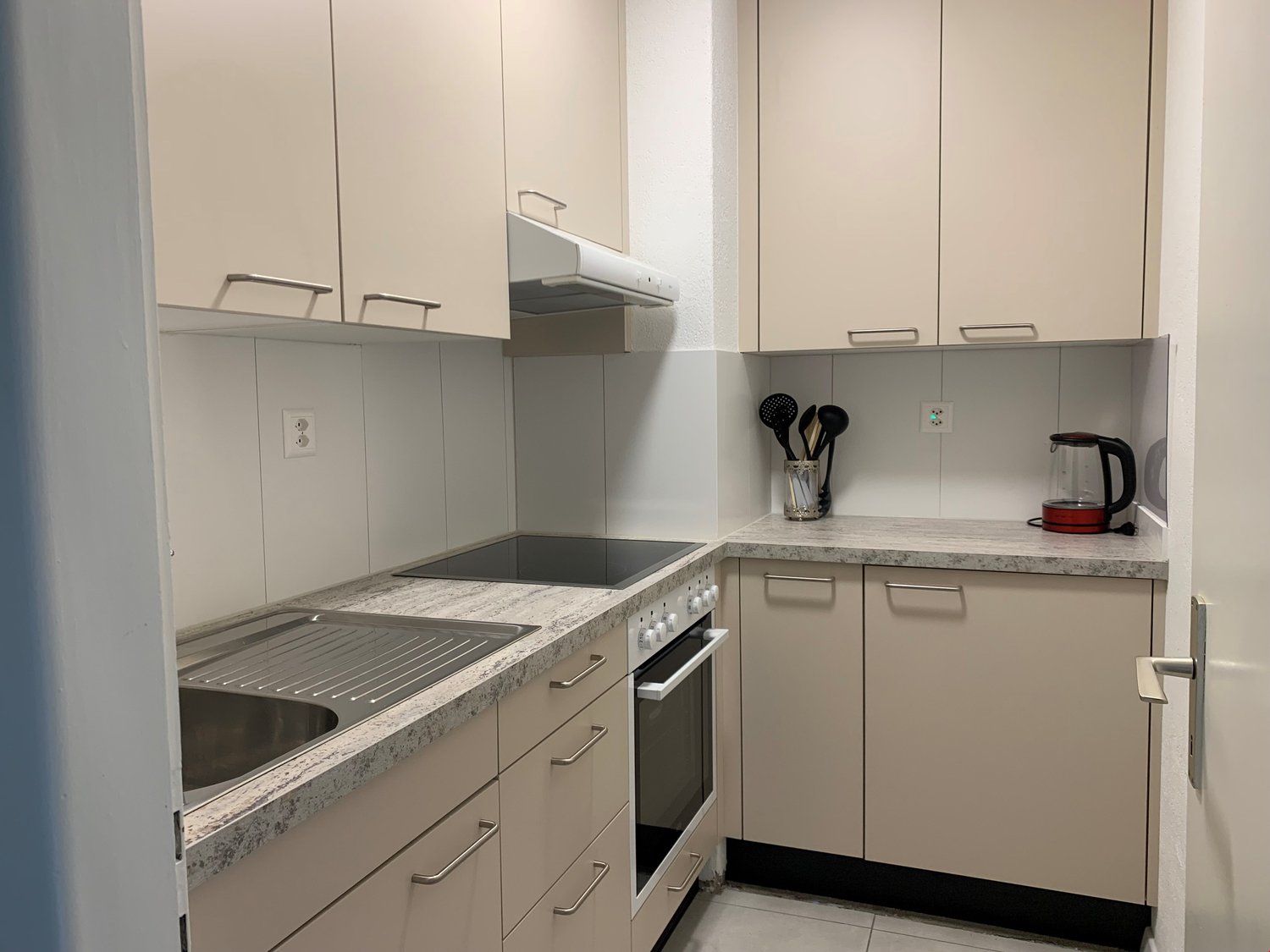 modern kitchen with granite countertops, stainless steel sink, electric stove, oven, and dishwasher