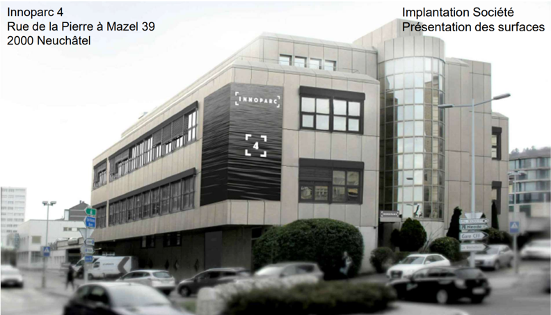 4-story office building with a modern, glass and concrete facade. The building is located on Rue de la Pierre à Mazel 39 in Neuchâtel, Switzerland and is part of the Innoparc 4 complex. There are several cars parked in front of the building.
