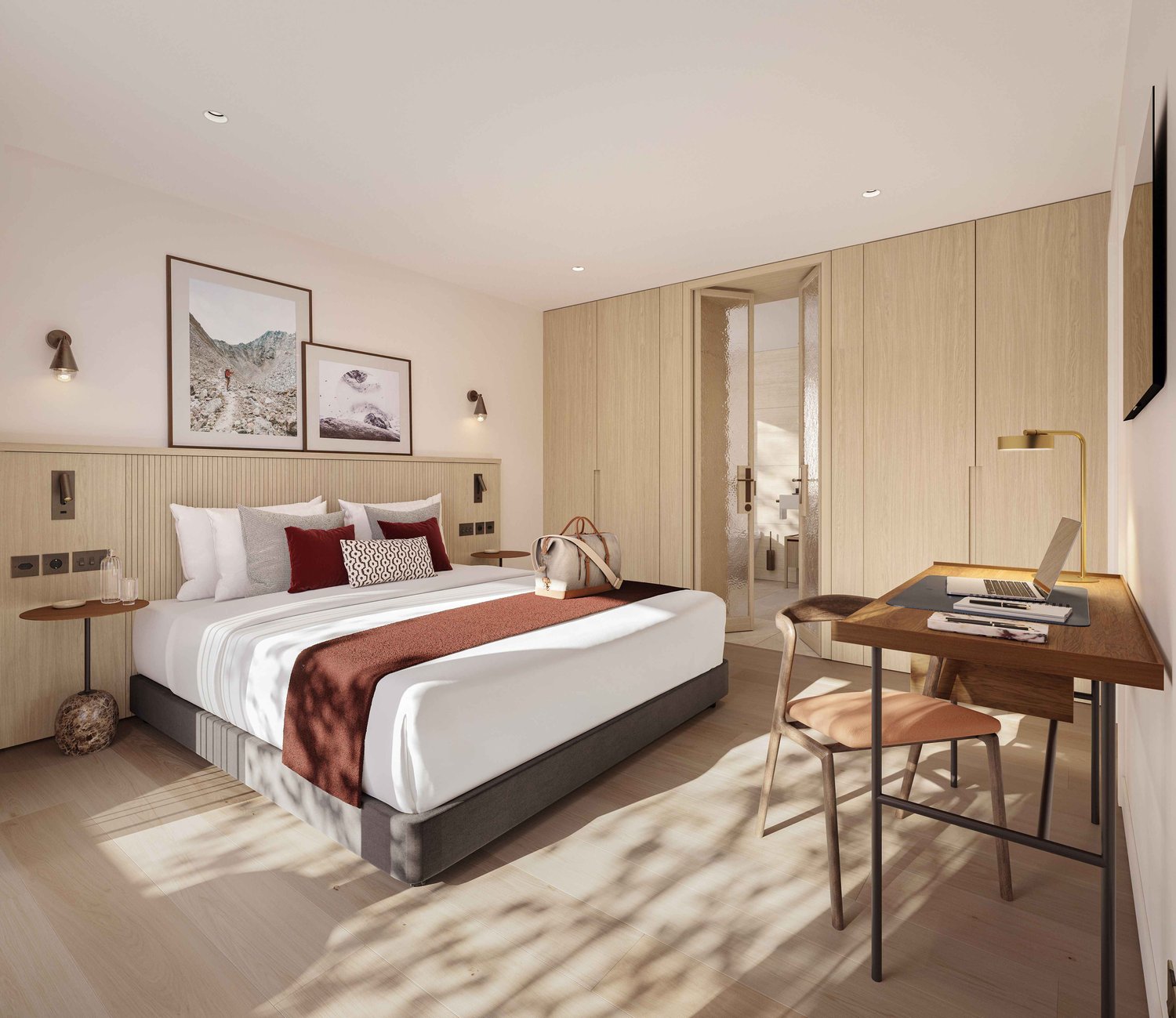 Large bed with pillows, desk with laptop, chair, wooden cabinet, nightstand with lamp, picture frames