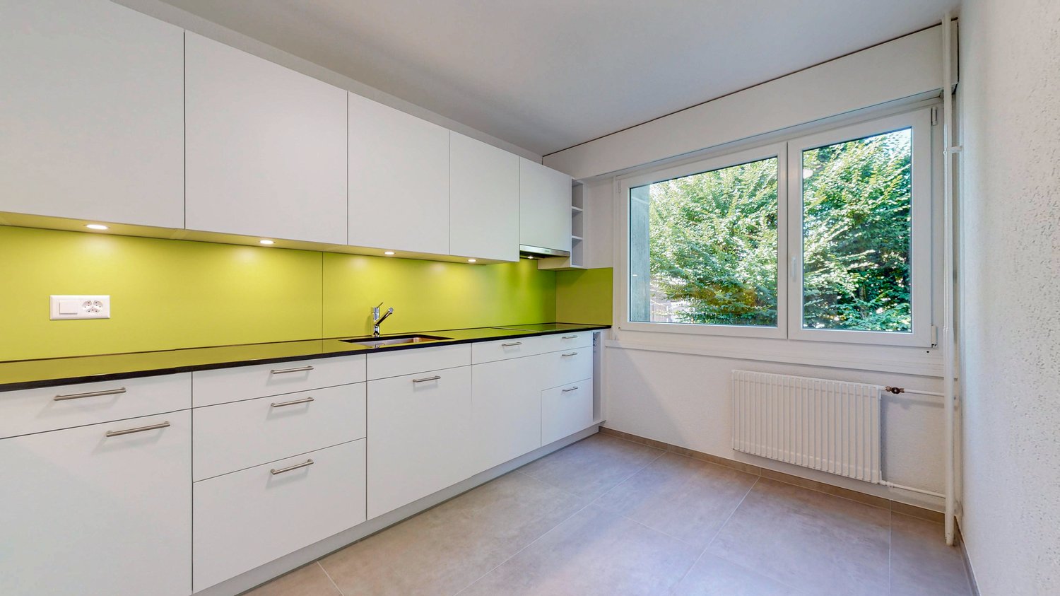 modern kitchen with white cabinets, yellow backsplash, granite countertop, stainless steel sink, faucet, large window with view of trees