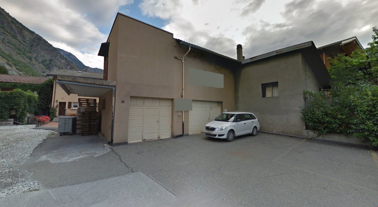 3 story house, beige exterior, double garage, driveway, white car parked