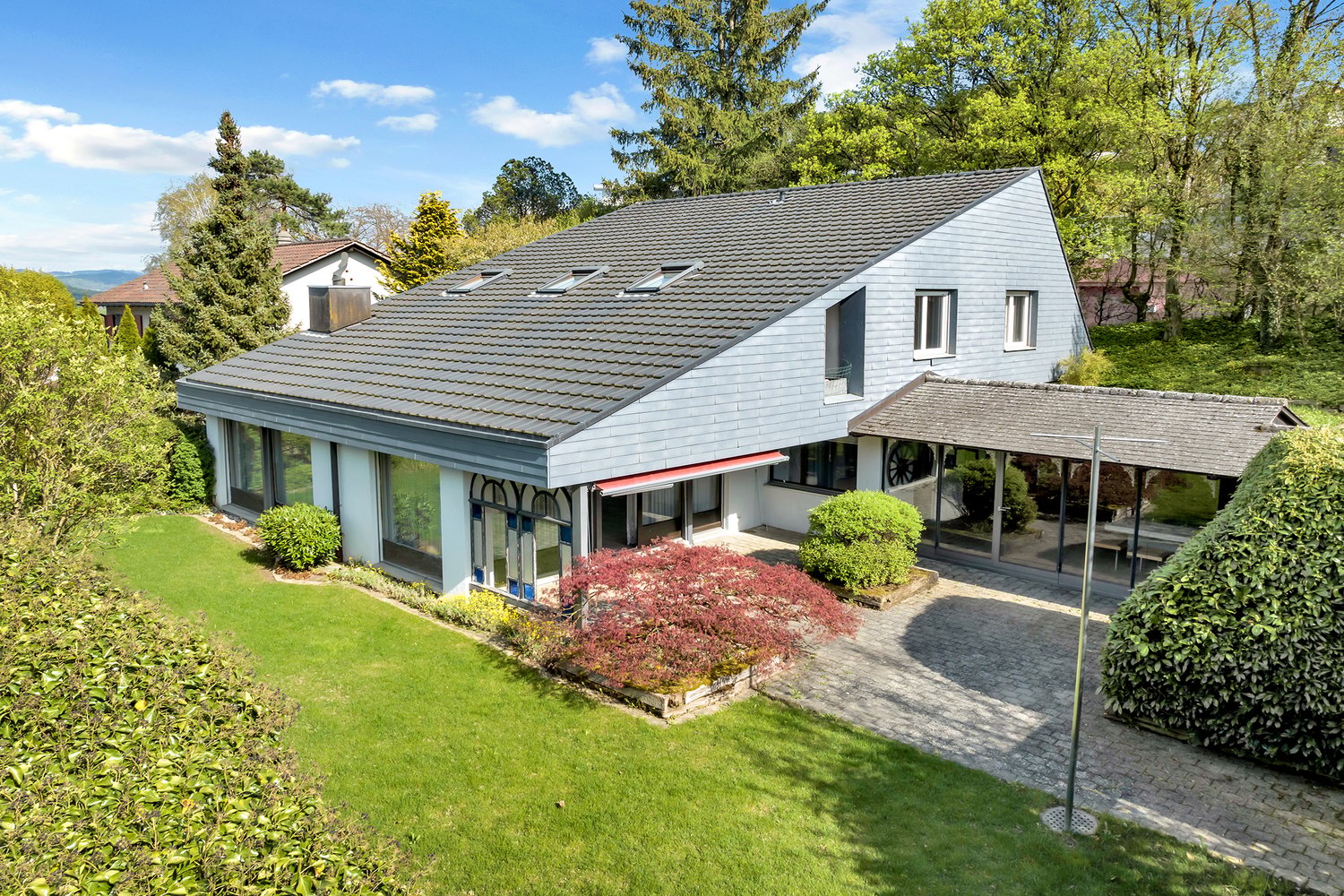 modern house, gray roof, glass windows, glass doors, terrace, garden, brick driveway