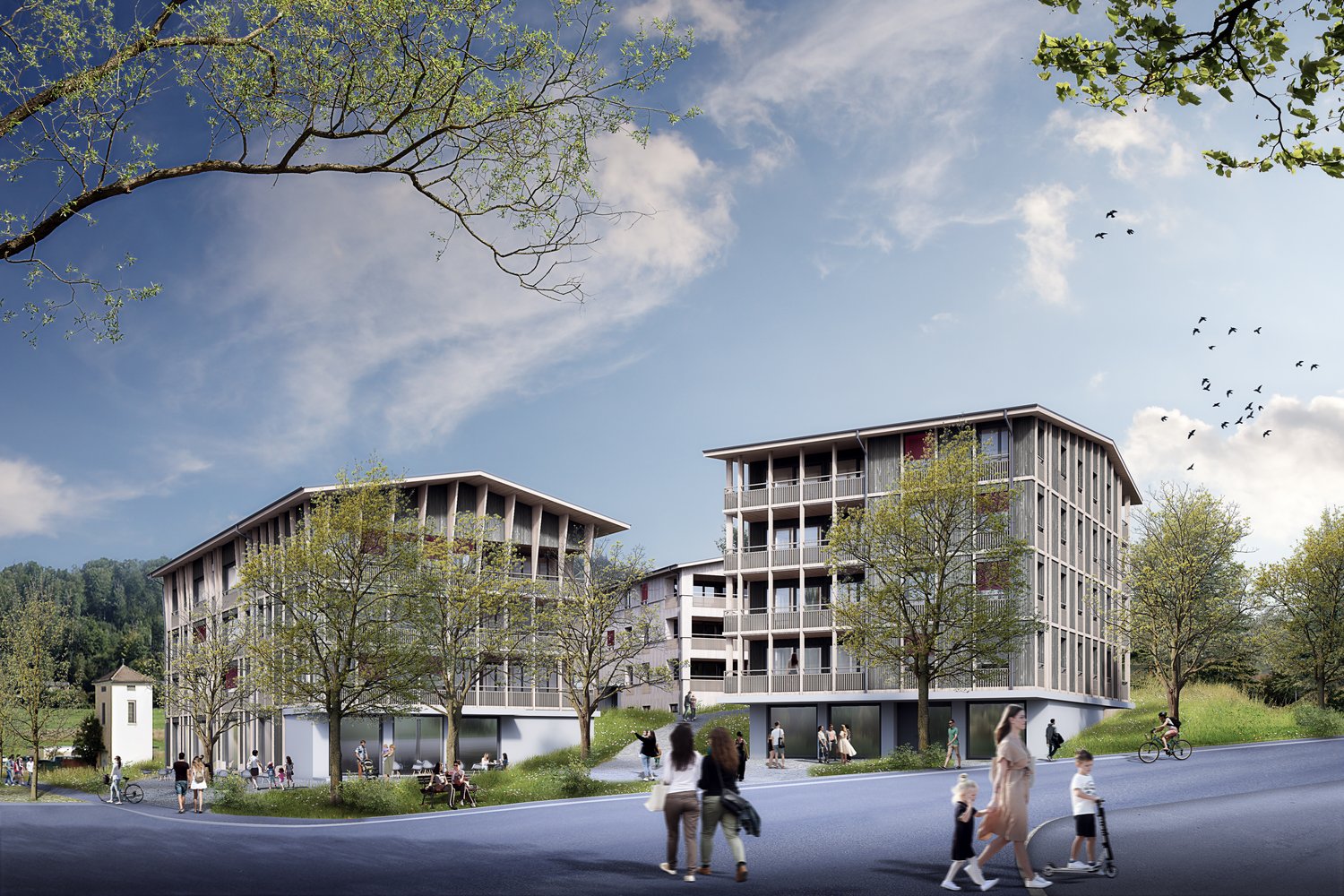 Modern apartment buildings with balconies, surrounded by trees and greenery, with a road and people walking