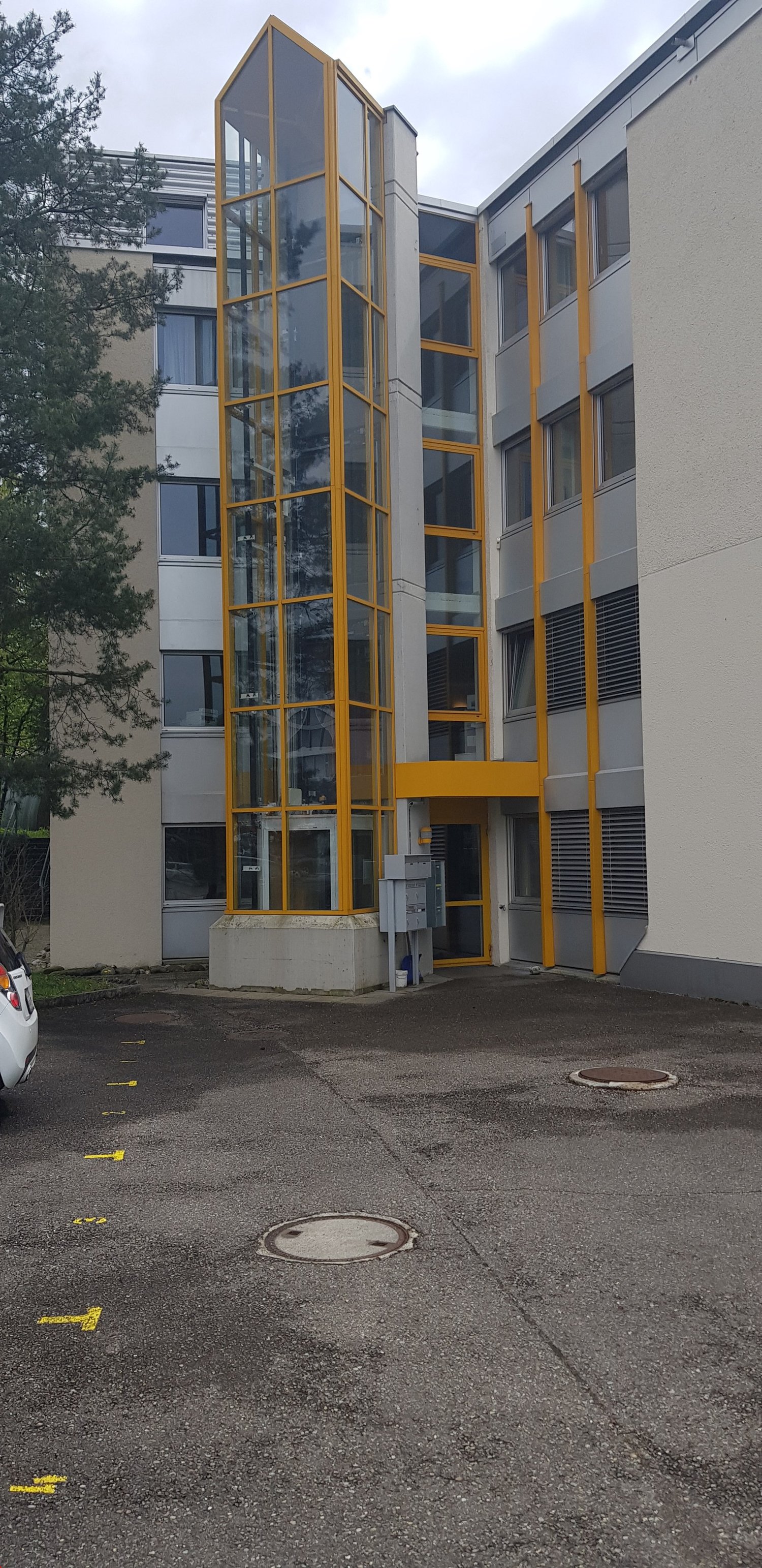 Two story office building with glass wall and entrance