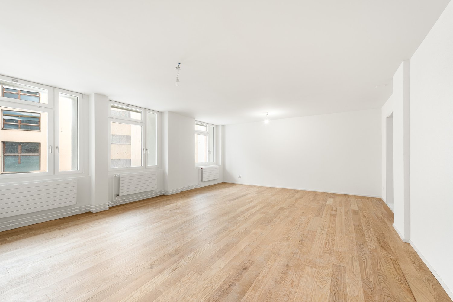 empty room, wooden floor, large windows, white walls