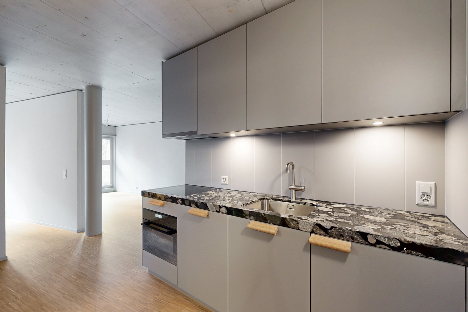 modern open kitchen with marble countertop, stainless steel sink, wooden cabinets, built-in dishwasher