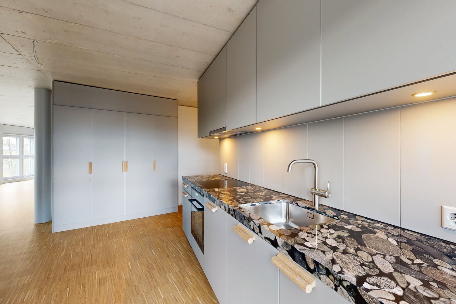 modern kitchen with granite countertop, silver sink, gray cabinets, wooden floors, double sink, electric stove