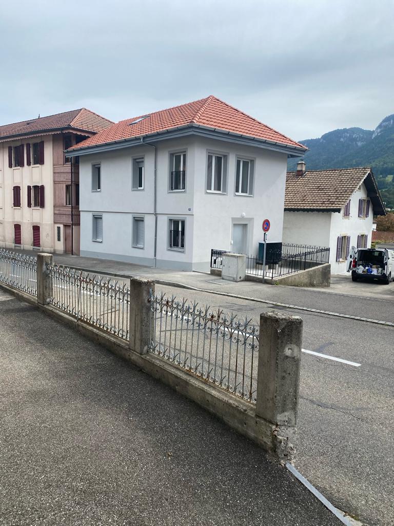 Building, red tiled roof, glass windows, metal fence, driveway