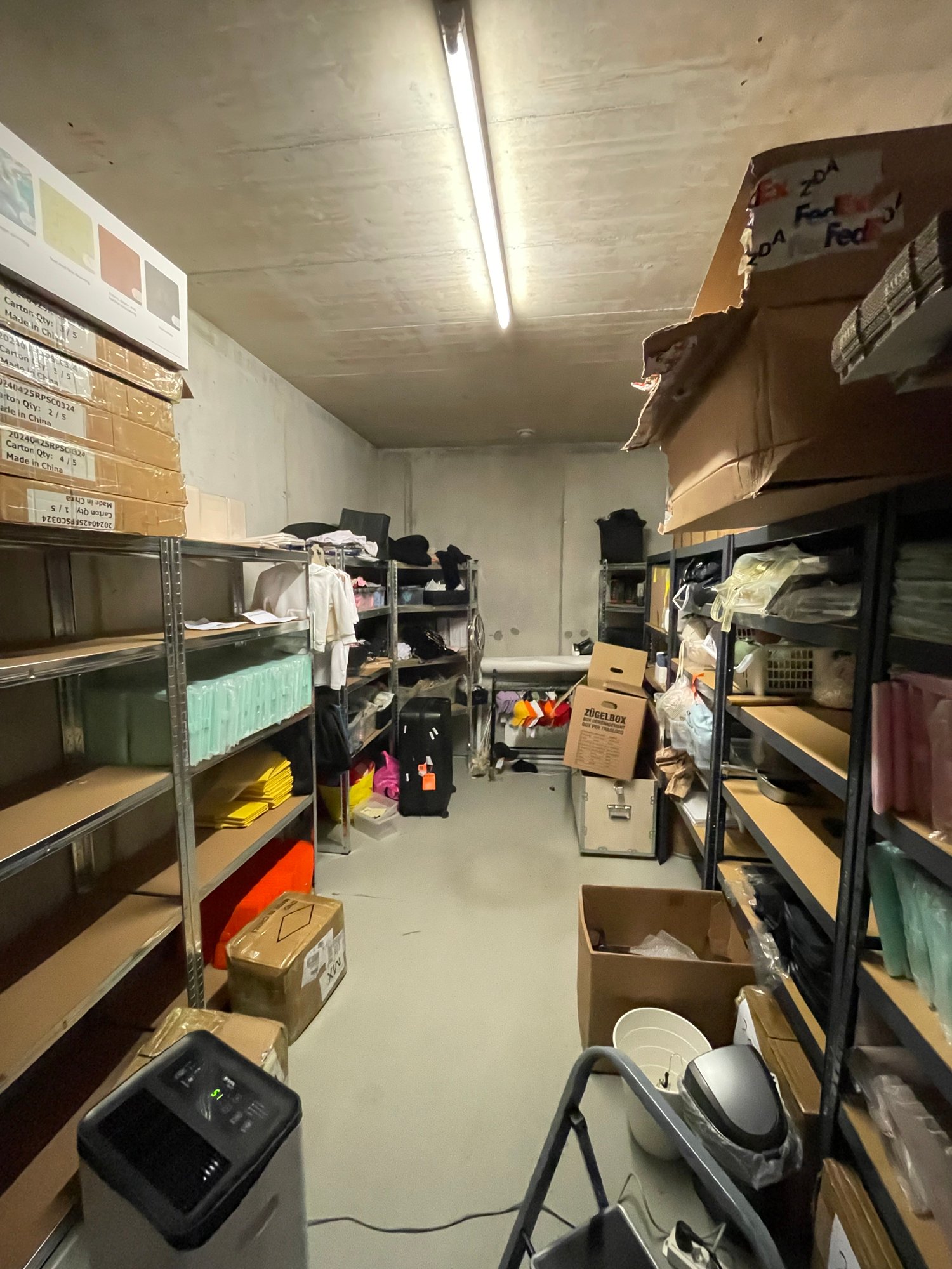 Storage room with shelves, boxes, and various items