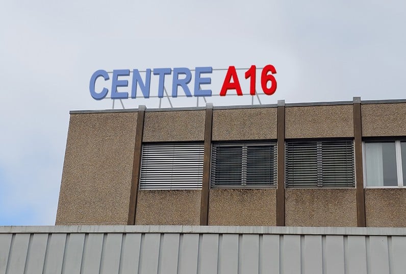 A multi-story commercial building with the text 'CENTRE A16' displayed prominently on the facade.