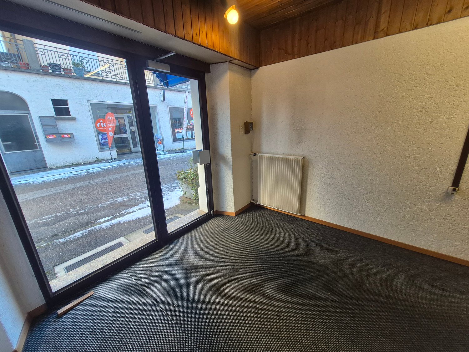 empty room, double glass doors, sliding glass doors, white walls, radiator
