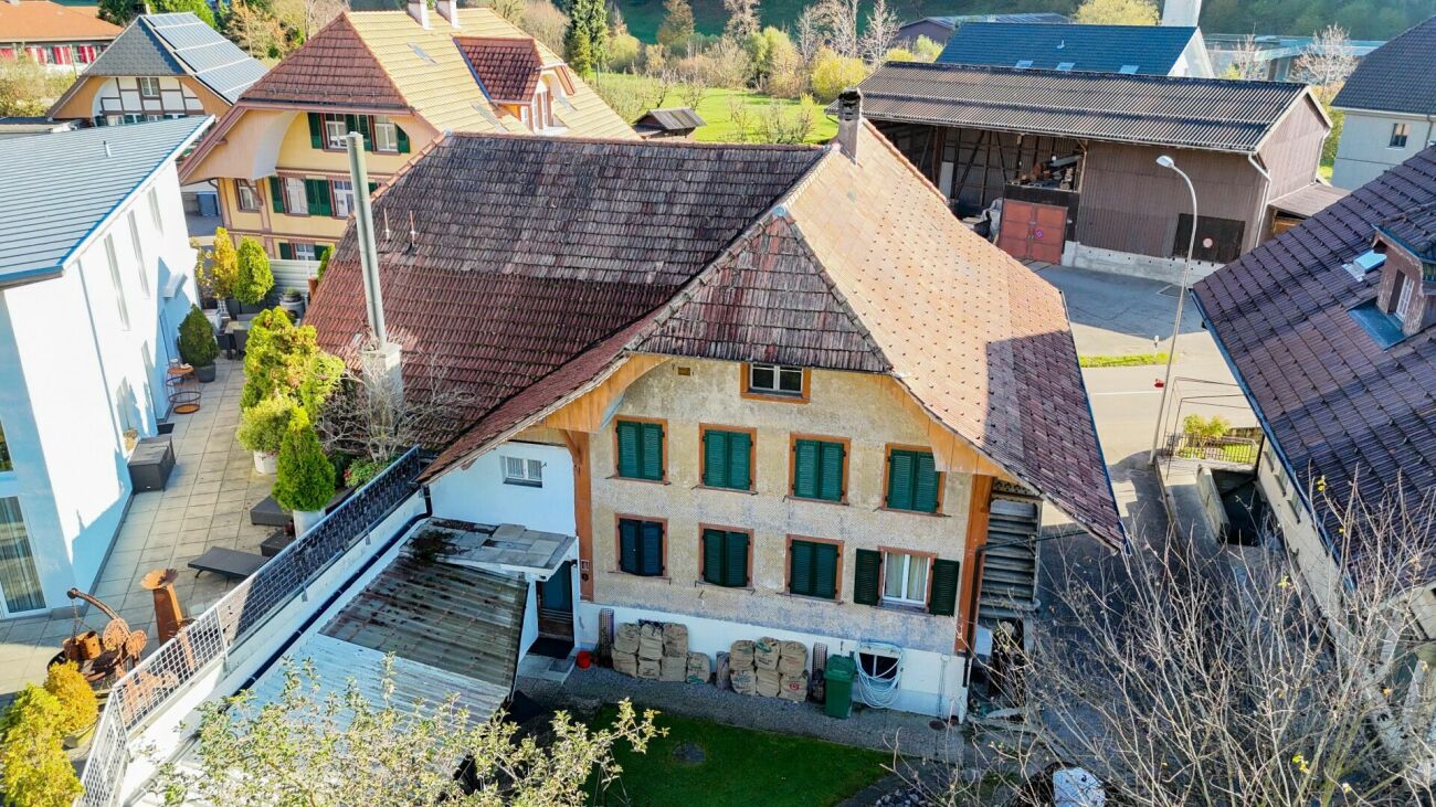 Two-family house with renovation needs and additional building land parcel