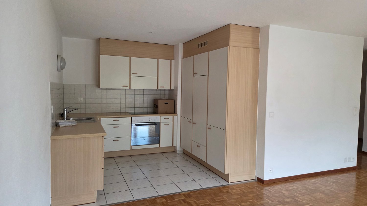 a kitchen with wooden countertops, an oven, a refrigerator, and a washing machine