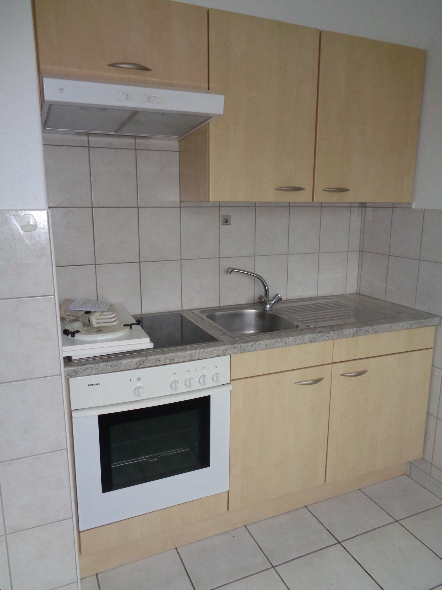 kitchen with oven, sink, cabinets, tiled floor