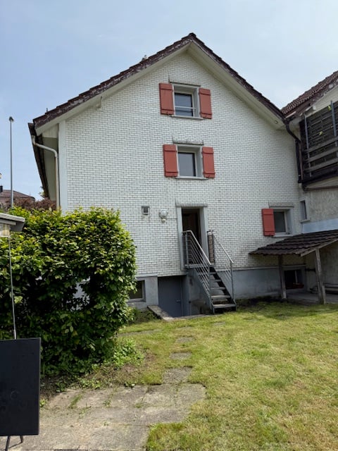 2 story house, white brick, red shutters, stairs, garage