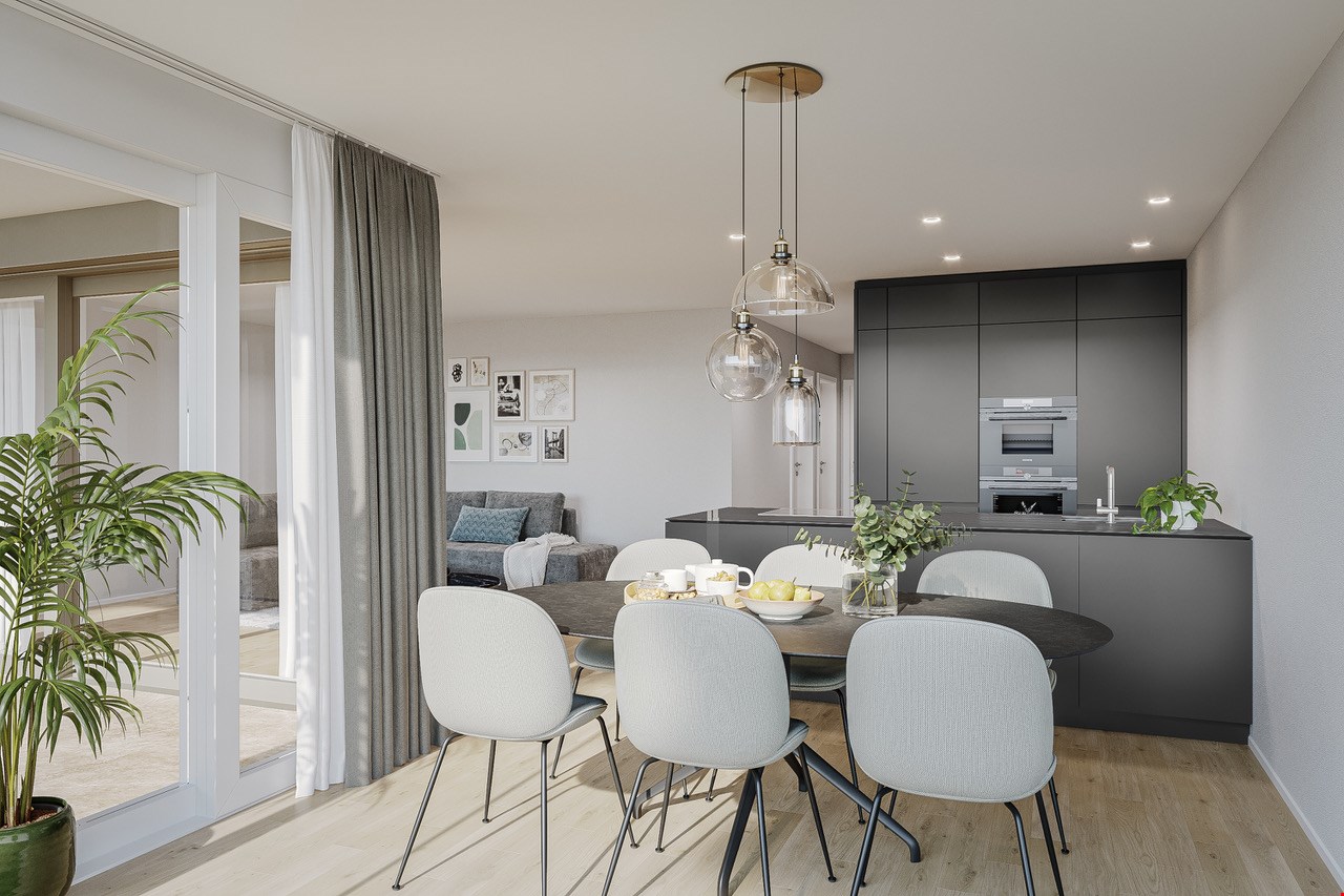 Open-concept living room and kitchen with large windows, gray curtains, round dining table with white chairs, gray sofa, black kitchen cabinets, and pendant lighting fixtures.