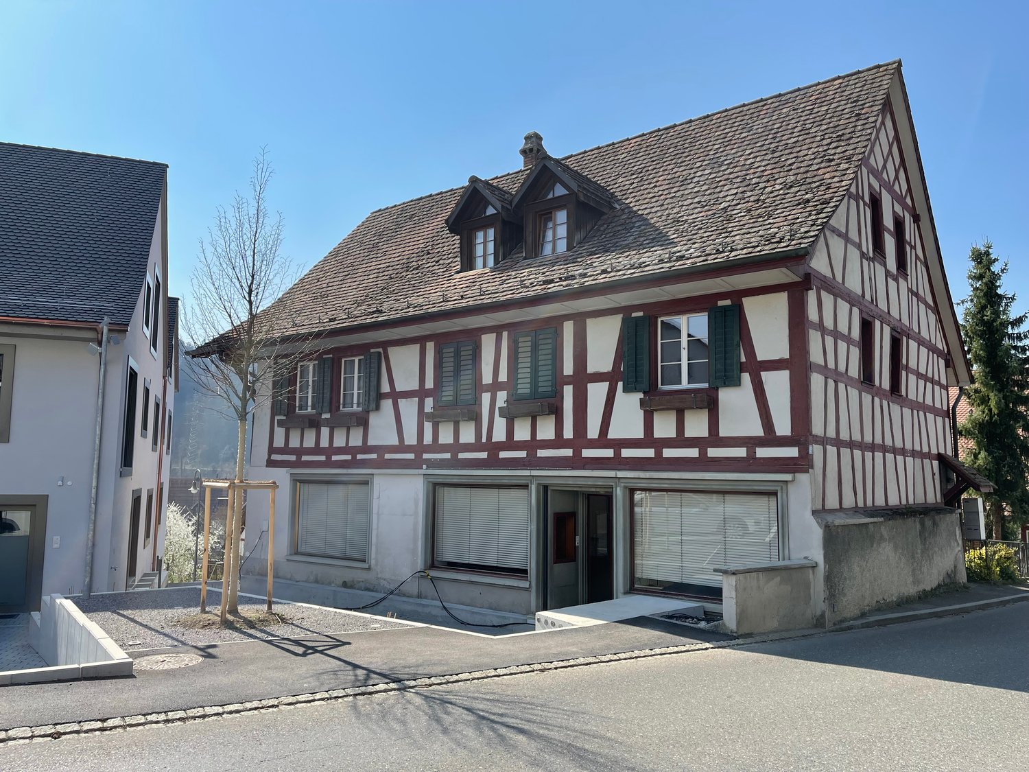 2 story house, brown roof, white and brown walls, garage