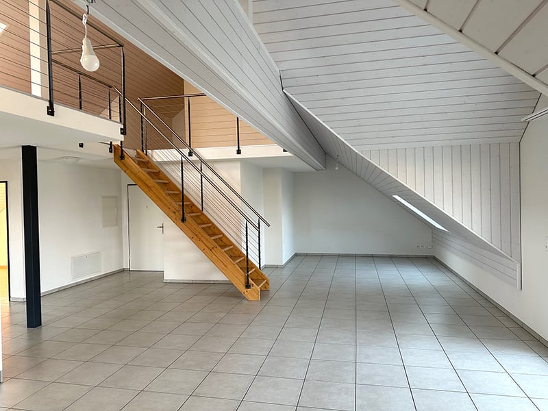 empty room, wooden stairs, white walls, tiled floor, metal railings, balcony
