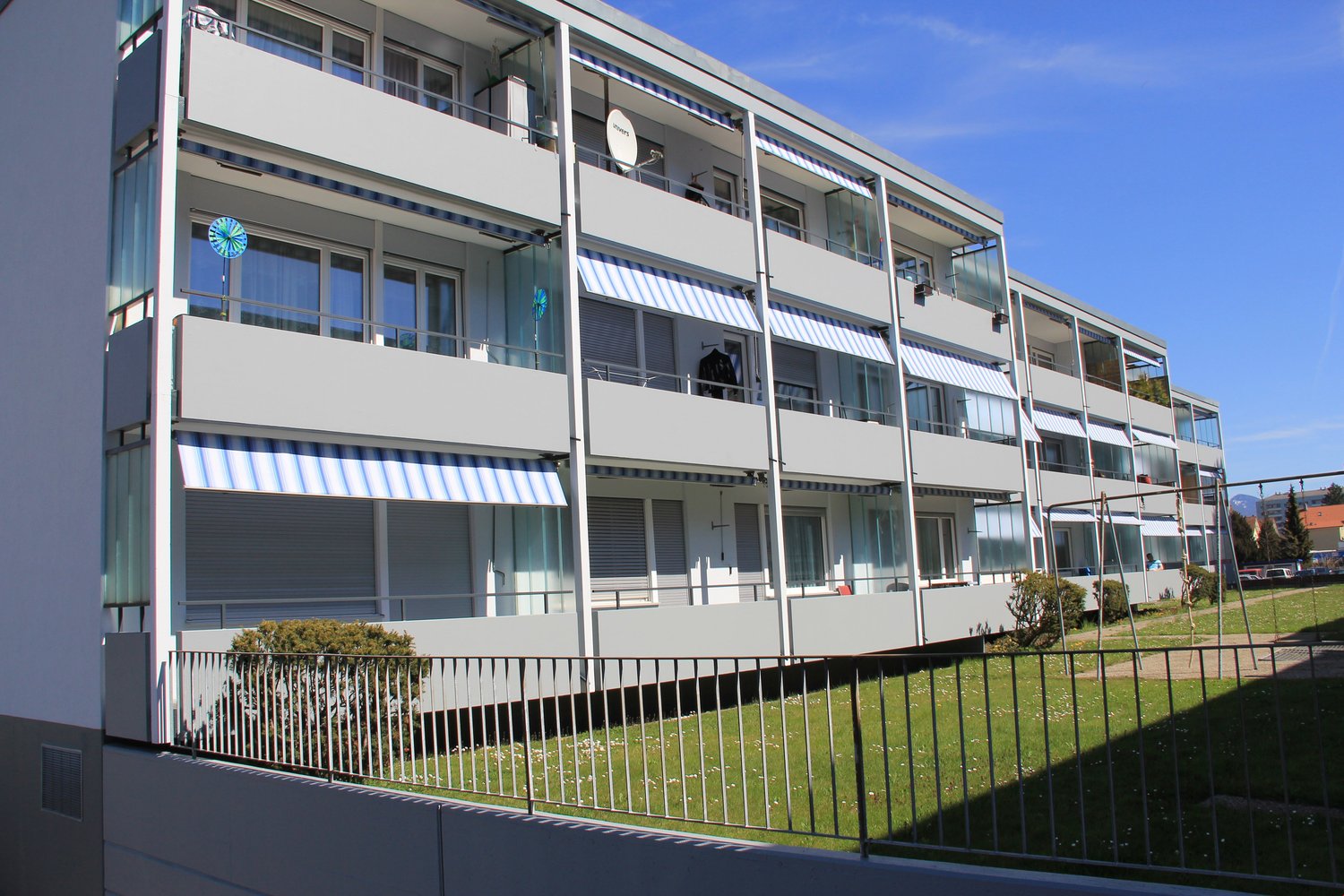4-story apartment building with balconies and windows