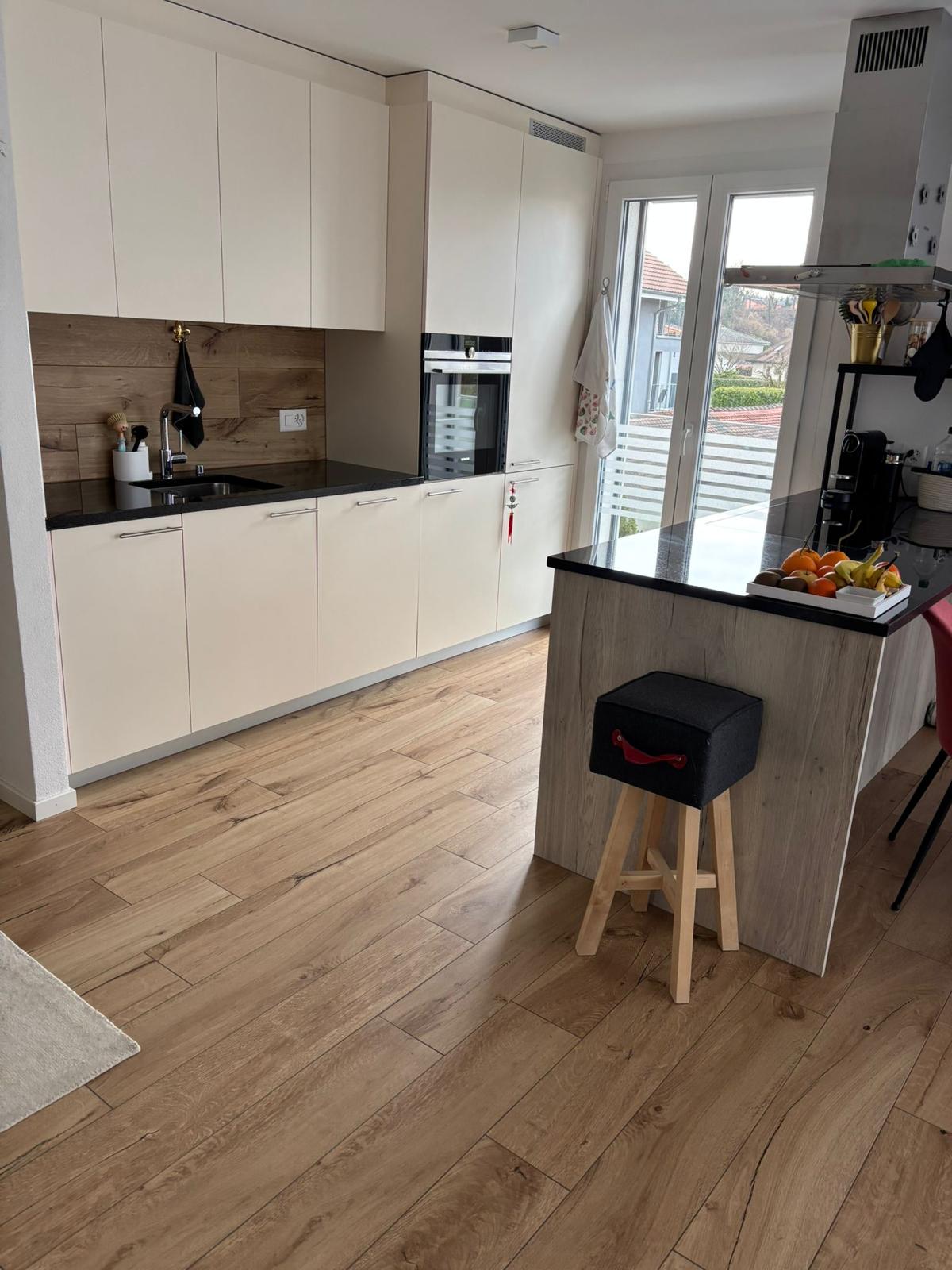white kitchen, wood floor, island, oven, sink, modern appliances