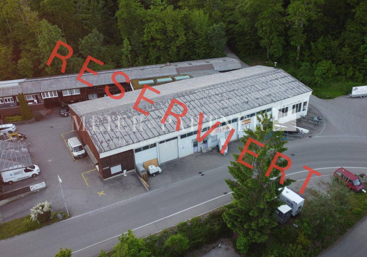 Industrial building with multiple parking spaces in front